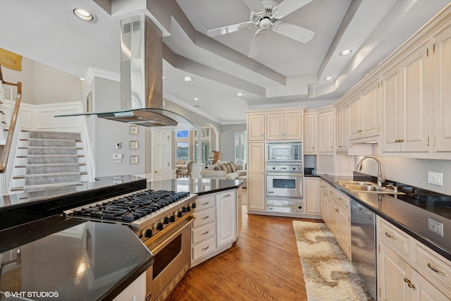 400 Lake Dr Unit C, New Buffalo, MI 49117 - kitchen featuring stainless steel appliances, island range hood, dark countertops, light wood-type flooring, and recessed lighting