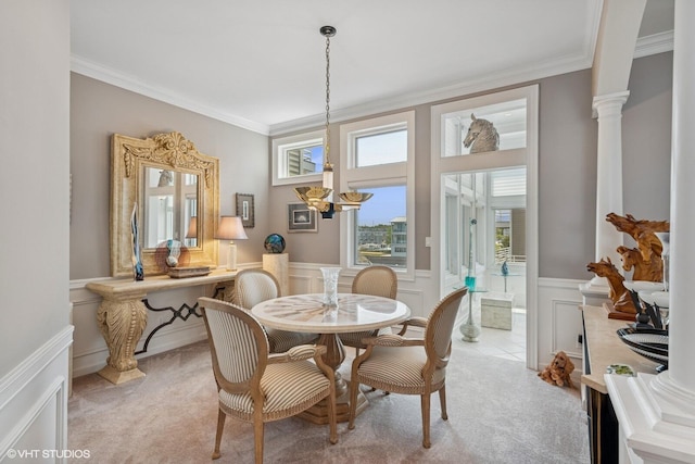 400 Lake Dr Unit C, New Buffalo, MI 49117 - dining space with light colored carpet, crown molding, a wainscoted wall, a decorative wall, and ornate columns