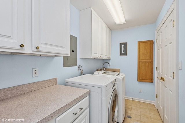 400 Lake Dr Unit C, New Buffalo, MI 49117 - laundry area featuring washer and clothes dryer, cabinet space, electric panel, and light tile patterned flooring