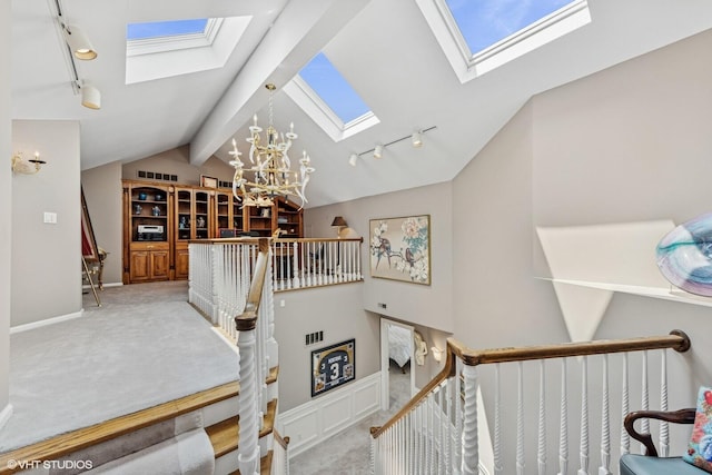 400 Lake Dr Unit C, New Buffalo, MI 49117 - stairs featuring a skylight, rail lighting, and a chandelier