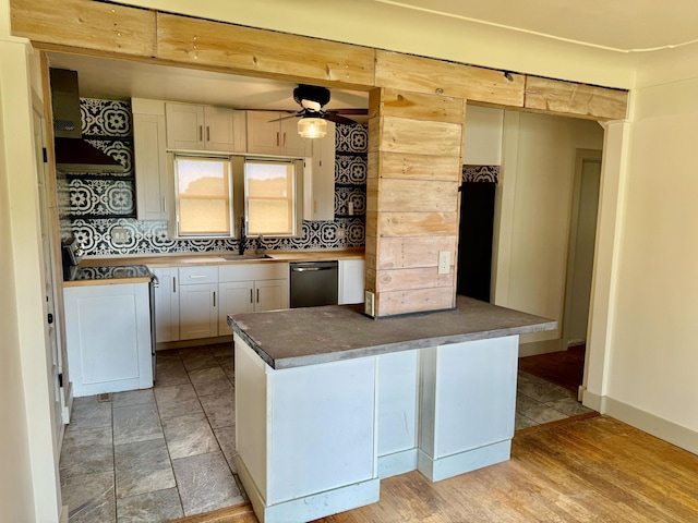 4691 2nd St, Caledonia, MI 49316 - kitchen with stainless steel dishwasher, premium range hood, ceiling fan, decorative backsplash, and white cabinets