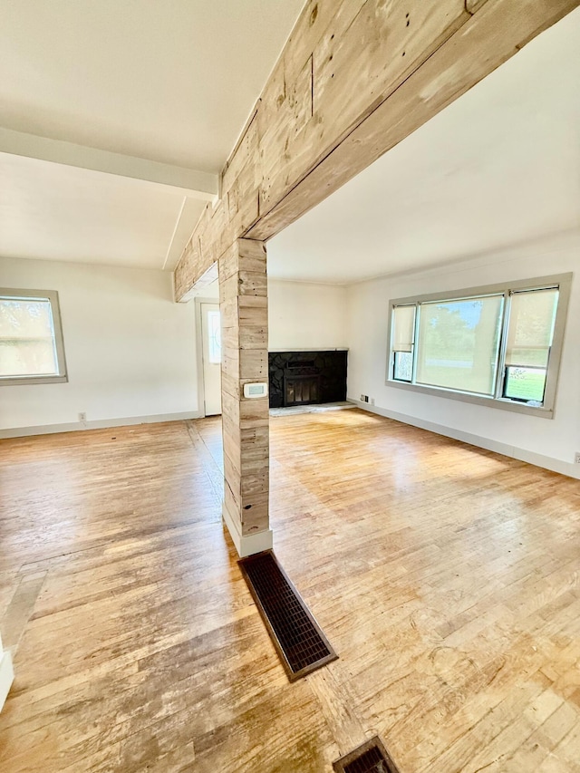 4691 2nd St, Caledonia, MI 49316 - unfurnished living room featuring wood finished floors and a multi sided fireplace