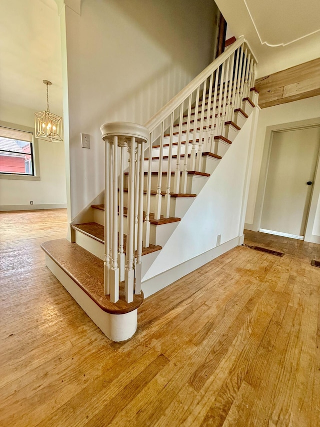 4691 2nd St, Caledonia, MI 49316 - staircase with wood finished floors and a chandelier
