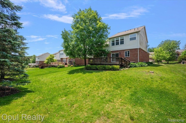 1978 Frances Way, Ypsilanti, MI 48198 - back of property with a wooden deck, brick siding, and a lawn