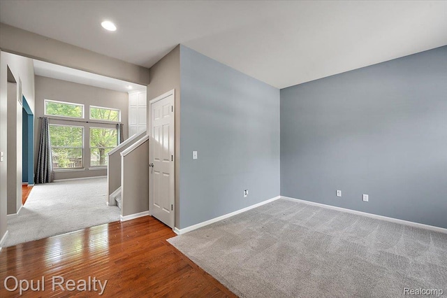 1978 Frances Way, Ypsilanti, MI 48198 - spare room with stairway, recessed lighting, wood finished floors, and carpet flooring