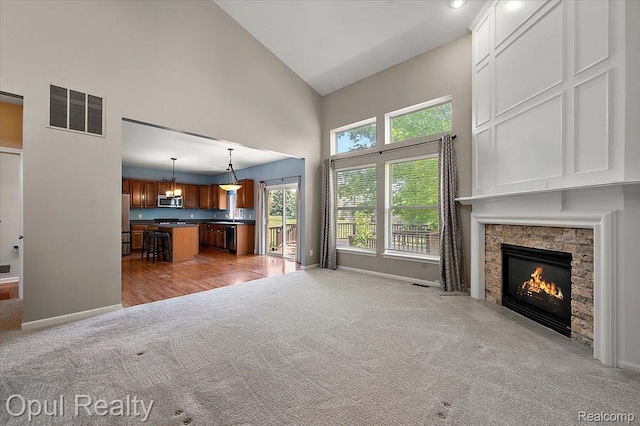 1978 Frances Way, Ypsilanti, MI 48198 - unfurnished living room with light carpet, high vaulted ceiling, and a fireplace