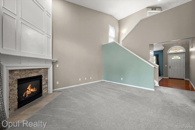 1978 Frances Way, Ypsilanti, MI 48198 - unfurnished living room with carpet floors, plenty of natural light, high vaulted ceiling, stairs, and a fireplace