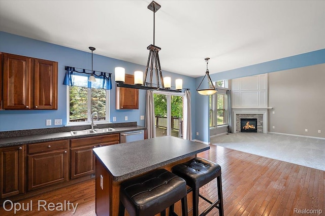1978 Frances Way, Ypsilanti, MI 48198 - kitchen featuring dark countertops, hardwood / wood-style floors, a lit fireplace, and a center island