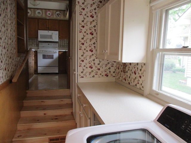 507 Mackinaw St, Durand, MI 48429 - kitchen featuring white appliances, wallpapered walls, light countertops, healthy amount of natural light, and tasteful backsplash