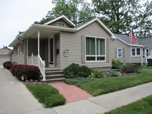 507 Mackinaw St, Durand, MI 48429 - view of front of property with a porch, a front yard, and a garage