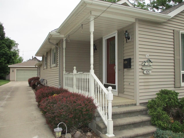 507 Mackinaw St, Durand, MI 48429 - view of front facade featuring covered porch, an outdoor structure, and a detached garage