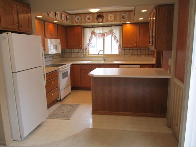 507 Mackinaw St, Durand, MI 48429 - kitchen with white appliances, light flooring, brown cabinets, light countertops, and tasteful backsplash