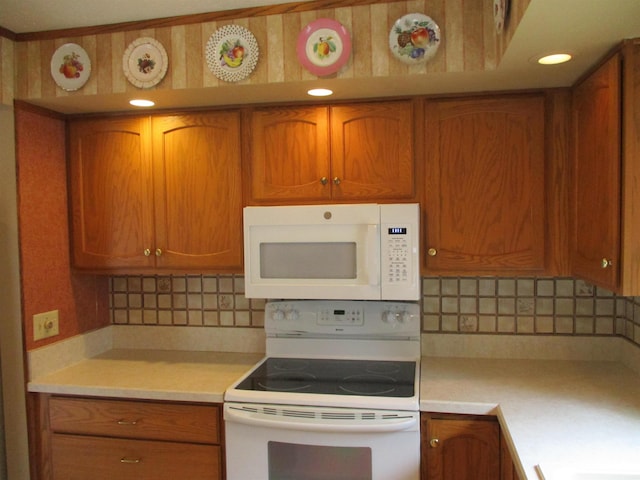 507 Mackinaw St, Durand, MI 48429 - kitchen featuring white appliances, light countertops, and brown cabinets