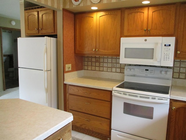 507 Mackinaw St, Durand, MI 48429 - kitchen with white appliances, brown cabinets, light countertops, and tasteful backsplash
