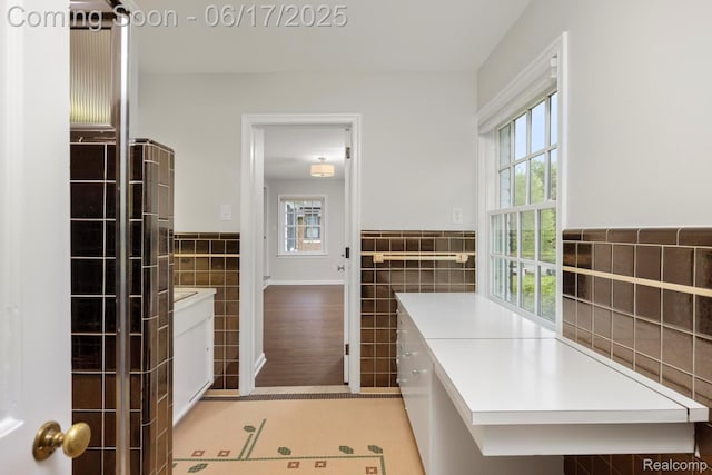33 Oxford Blvd, Pleasant Ridge, MI 48069 - bathroom featuring tile walls, healthy amount of natural light, vanity, wainscoting, and tile patterned floors