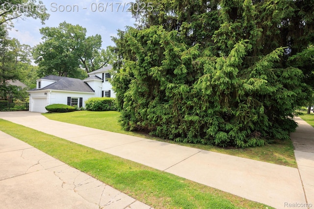 33 Oxford Blvd, Pleasant Ridge, MI 48069 - view of property hidden behind natural elements featuring a front lawn, a garage, and driveway