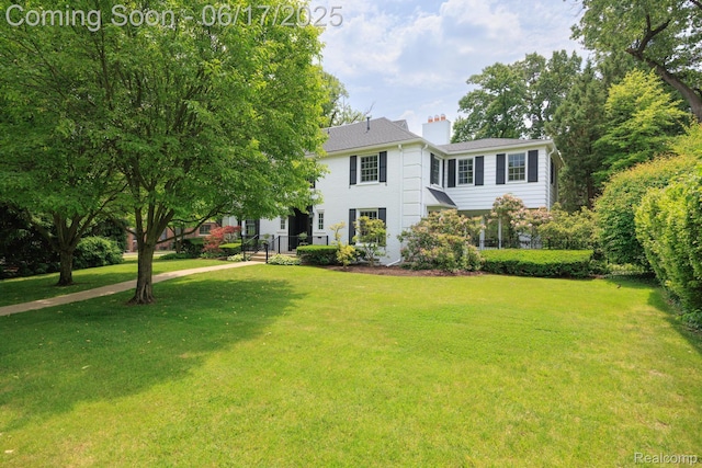 33 Oxford Blvd, Pleasant Ridge, MI 48069 - view of front of house featuring a chimney and a front lawn