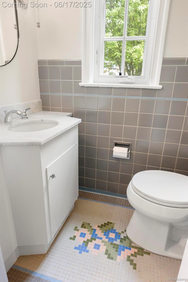33 Oxford Blvd, Pleasant Ridge, MI 48069 - half bathroom featuring vanity, tile walls, tile patterned flooring, and a wainscoted wall