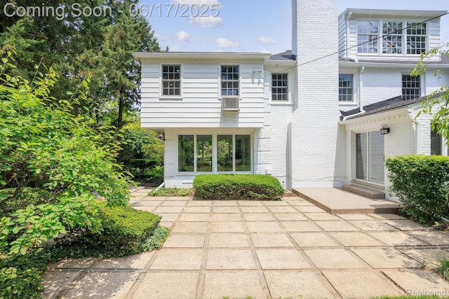 33 Oxford Blvd, Pleasant Ridge, MI 48069 - back of property with a chimney, brick siding, a patio area, and cooling unit