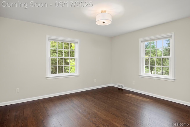 33 Oxford Blvd, Pleasant Ridge, MI 48069 - empty room featuring healthy amount of natural light and dark wood-style flooring
