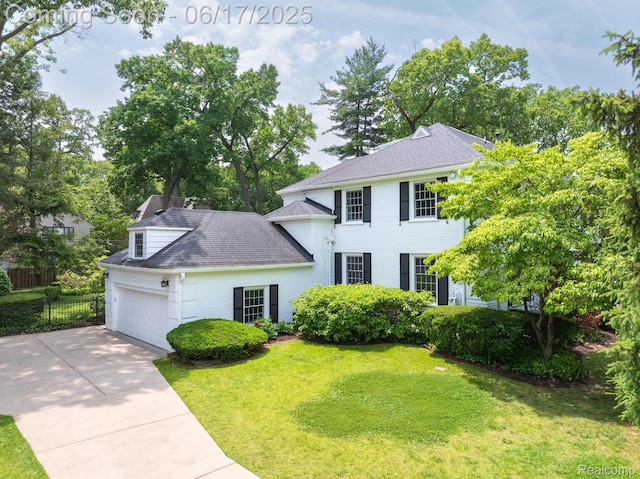 33 Oxford Blvd, Pleasant Ridge, MI 48069 - colonial home featuring concrete driveway, a garage, roof with shingles, and brick siding