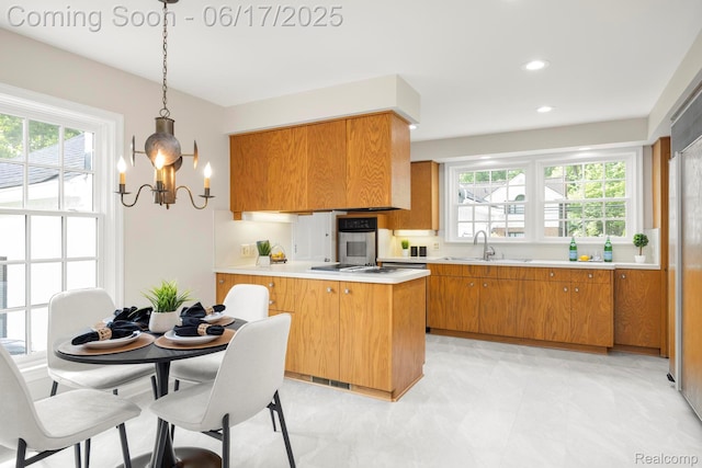 33 Oxford Blvd, Pleasant Ridge, MI 48069 - kitchen featuring brown cabinets, light countertops, plenty of natural light, stainless steel oven, and recessed lighting