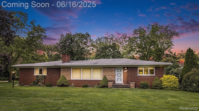 21556 Thorofare Rd, Trenton, MI 48138 - view of front of house with a yard, brick siding, and a chimney