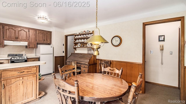 21556 Thorofare Rd, Trenton, MI 48138 - dining space with light colored carpet, wainscoting, and wooden walls