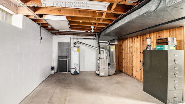 21556 Thorofare Rd, Trenton, MI 48138 - unfinished below grade area featuring gas water heater, heating unit, wood walls, and concrete block wall