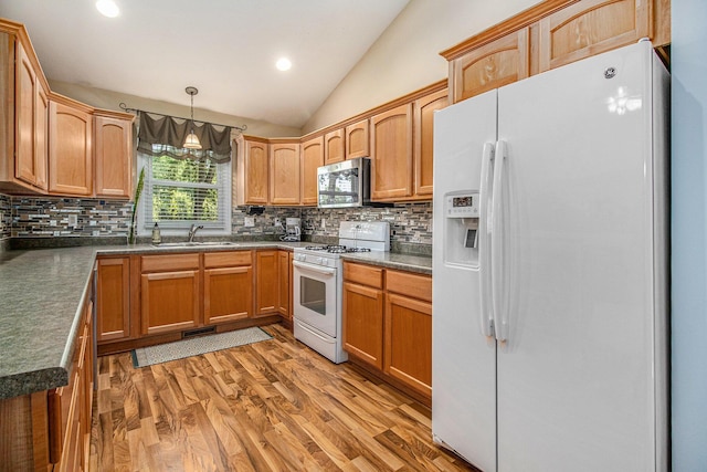 4497 Tiffany Ave, Portage, MI 49002 - kitchen with white appliances, vaulted ceiling, decorative backsplash, light wood-style floors, and dark countertops