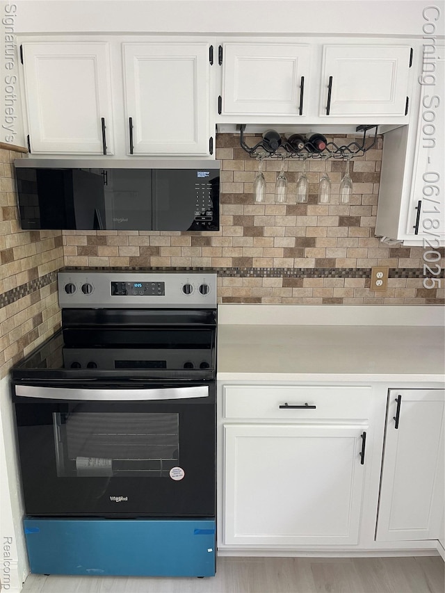 3834 Tara Dr, Highland, MI 48356 - kitchen featuring stainless steel range with electric cooktop and white cabinetry