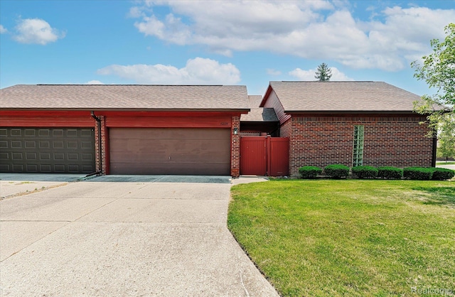 42134 Toddmark Ln, Clinton Township, MI 48038 - view of front of house with concrete driveway, brick siding, an attached garage, and a shingled roof