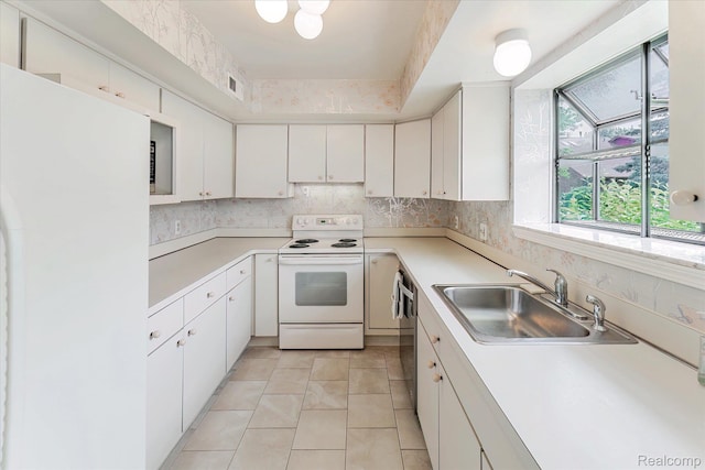 42134 Toddmark Ln, Clinton Township, MI 48038 - kitchen with white appliances, light countertops, white cabinetry, and light tile patterned floors