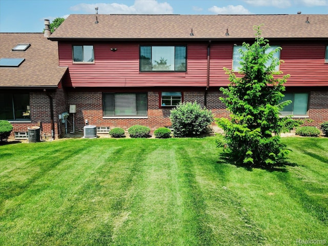 42134 Toddmark Ln, Clinton Township, MI 48038 - back of property with brick siding, a lawn, and a shingled roof