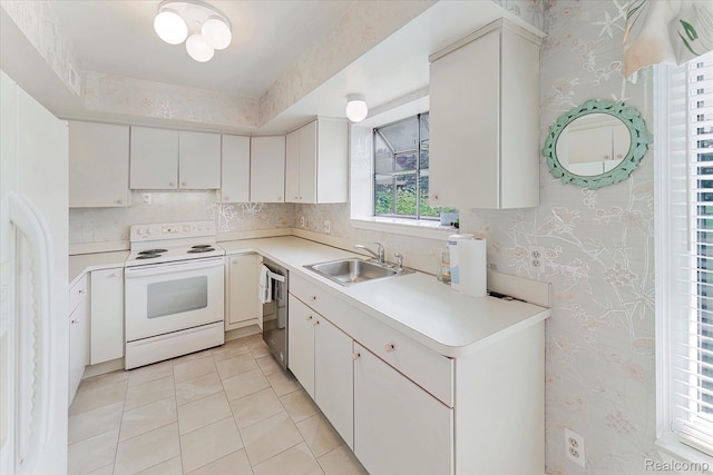 42134 Toddmark Ln, Clinton Township, MI 48038 - kitchen featuring white appliances, wallpapered walls, light tile patterned floors, light countertops, and white cabinetry