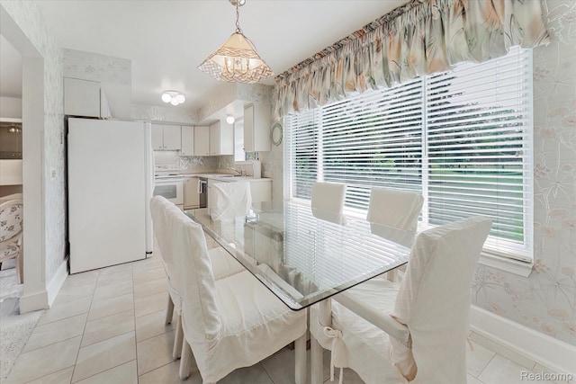 42134 Toddmark Ln, Clinton Township, MI 48038 - dining space with a chandelier, wallpapered walls, and light tile patterned floors