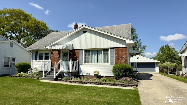 1107 Mccormick St, Monroe, MI 48162 - view of front of property featuring an outdoor structure, roof with shingles, a detached garage, and a front yard