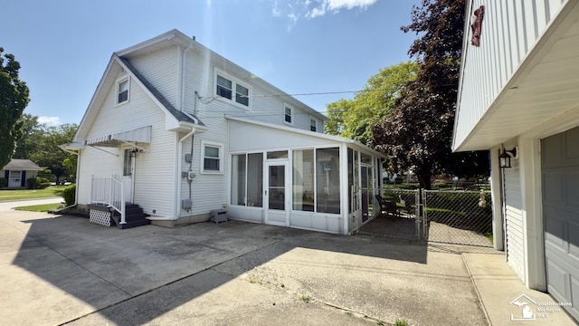 1107 Mccormick St, Monroe, MI 48162 - rear view of property featuring a sunroom and a gate