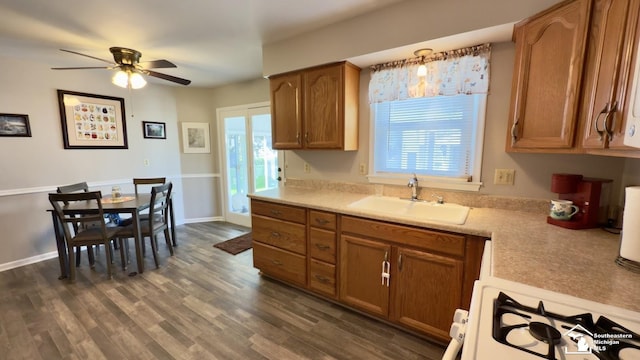 1107 Mccormick St, Monroe, MI 48162 - kitchen featuring a ceiling fan, brown cabinetry, light countertops, and dark wood-type flooring