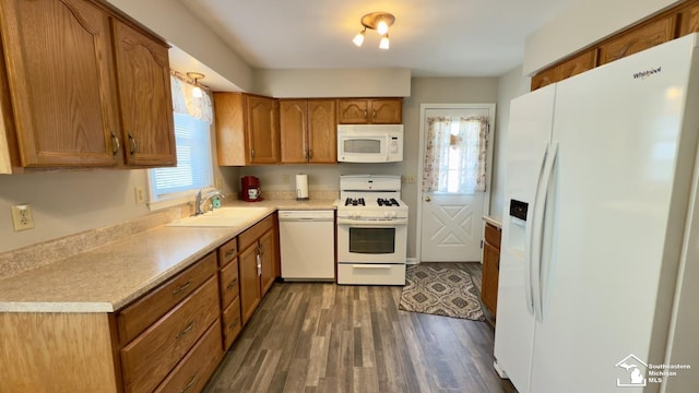 1107 Mccormick St, Monroe, MI 48162 - kitchen featuring white appliances, brown cabinets, dark wood-style flooring, and light countertops