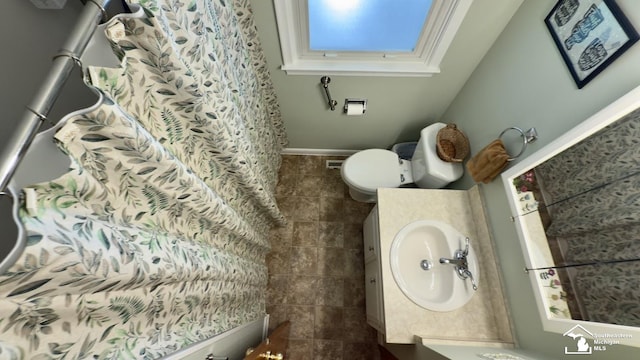 1107 Mccormick St, Monroe, MI 48162 - full bathroom with a skylight, vanity, tile patterned floors, and a shower with curtain