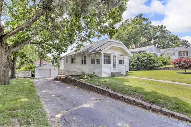 741 Lawrence St, Jackson, MI 49203 - view of front of property featuring a garage, an outbuilding, entry steps, and roof with shingles