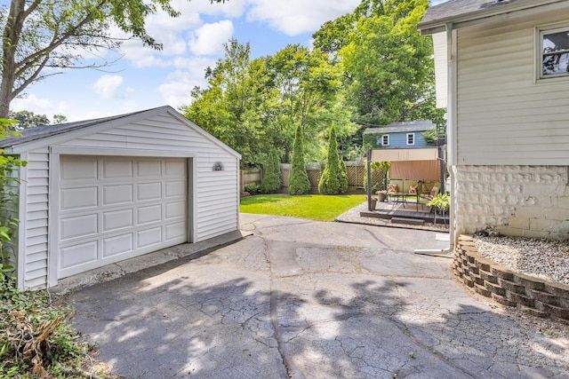 741 Lawrence St, Jackson, MI 49203 - detached garage featuring asphalt driveway