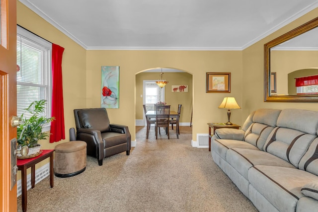 741 Lawrence St, Jackson, MI 49203 - carpeted living room featuring arched walkways, ornamental molding, and a chandelier