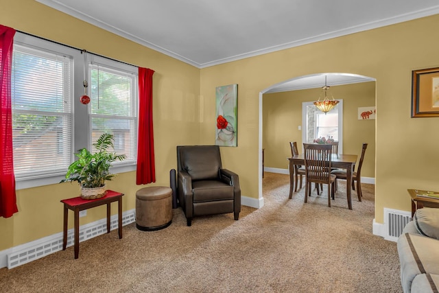 741 Lawrence St, Jackson, MI 49203 - living area with ornamental molding, arched walkways, plenty of natural light, carpet flooring, and a chandelier