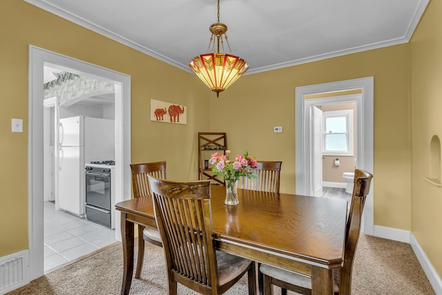 741 Lawrence St, Jackson, MI 49203 - dining area with arched walkways, crown molding, and light carpet