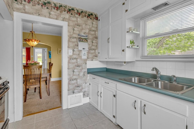 741 Lawrence St, Jackson, MI 49203 - kitchen with white cabinets, light tile patterned flooring, ornamental molding, open shelves, and tasteful backsplash