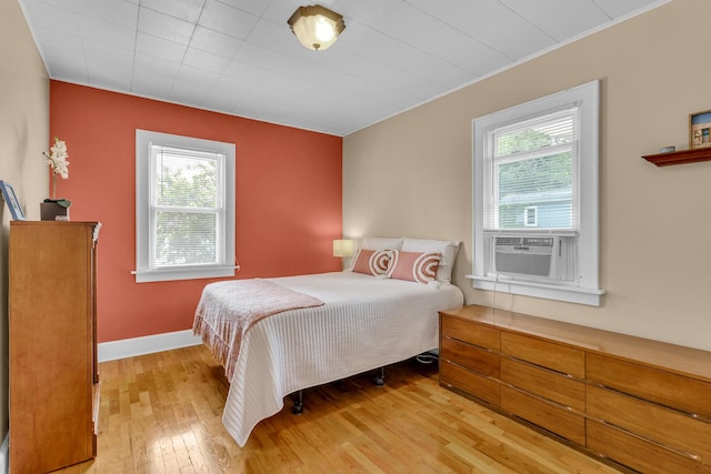 741 Lawrence St, Jackson, MI 49203 - bedroom with multiple windows, light wood-type flooring, cooling unit, and crown molding