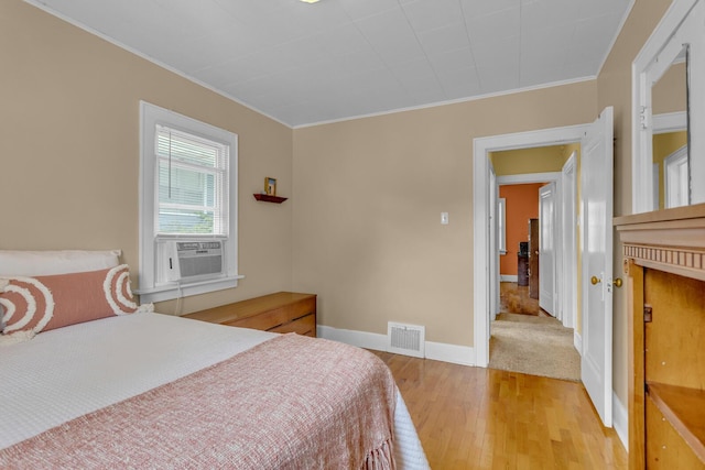 741 Lawrence St, Jackson, MI 49203 - bedroom with light wood finished floors, crown molding, and cooling unit