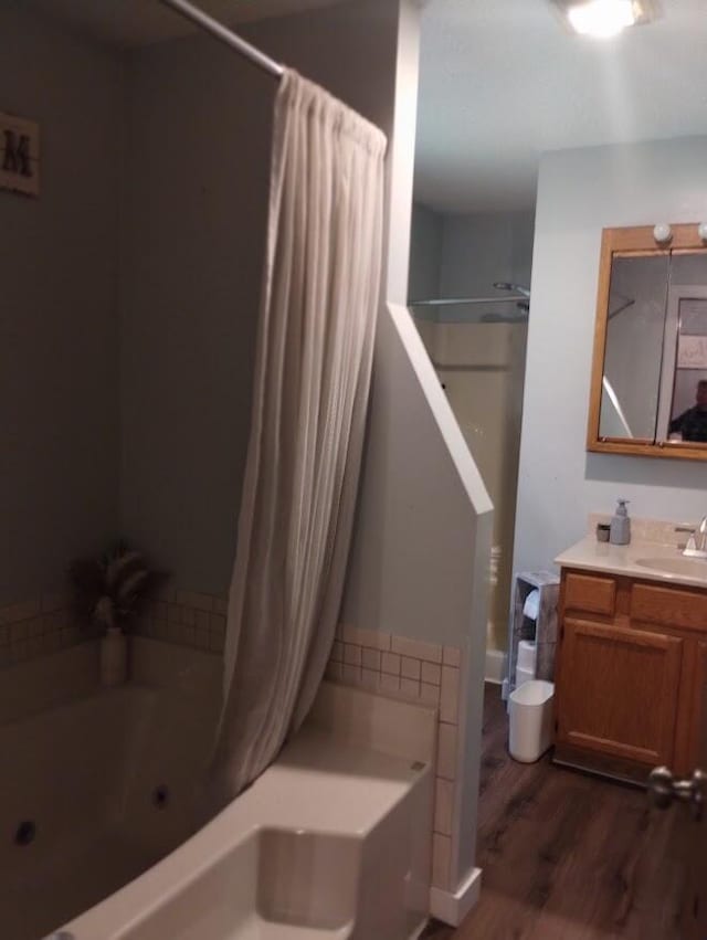 5664 Hall Rd, Muskegon, MI 49442 - full bath with wood finished floors, vanity, and a combined bath / shower with jetted tub